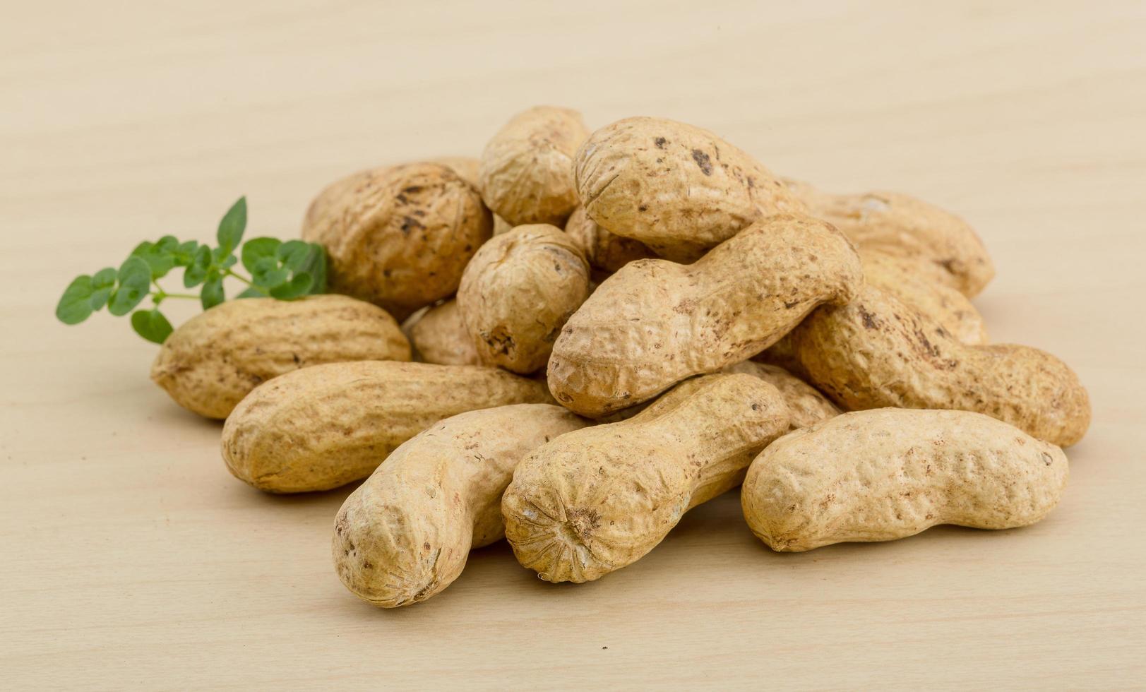 Raw peanuts on wood photo