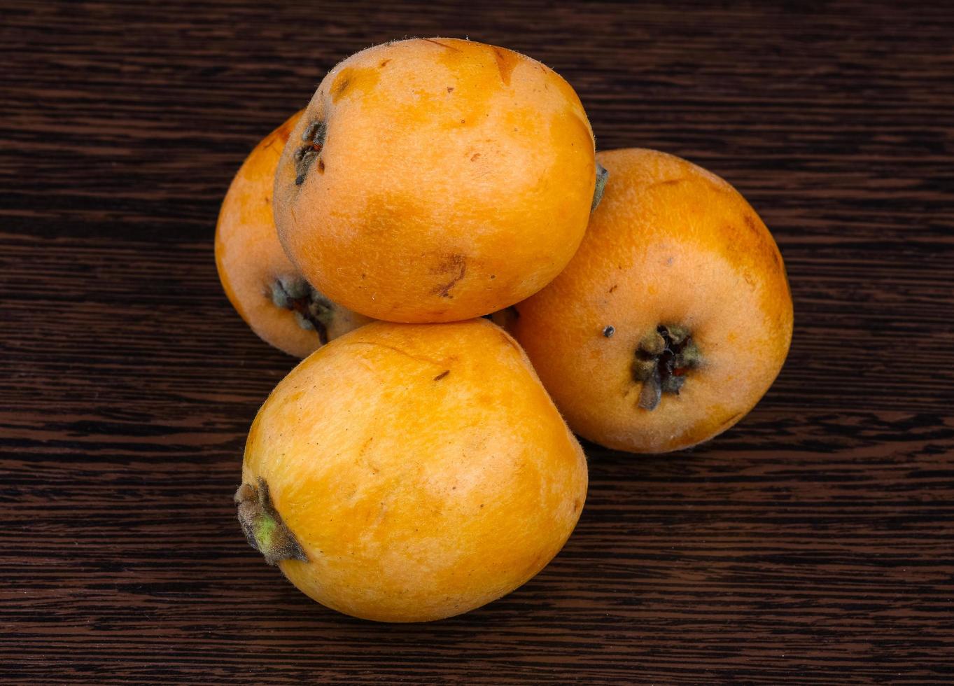 Medlar on wood photo