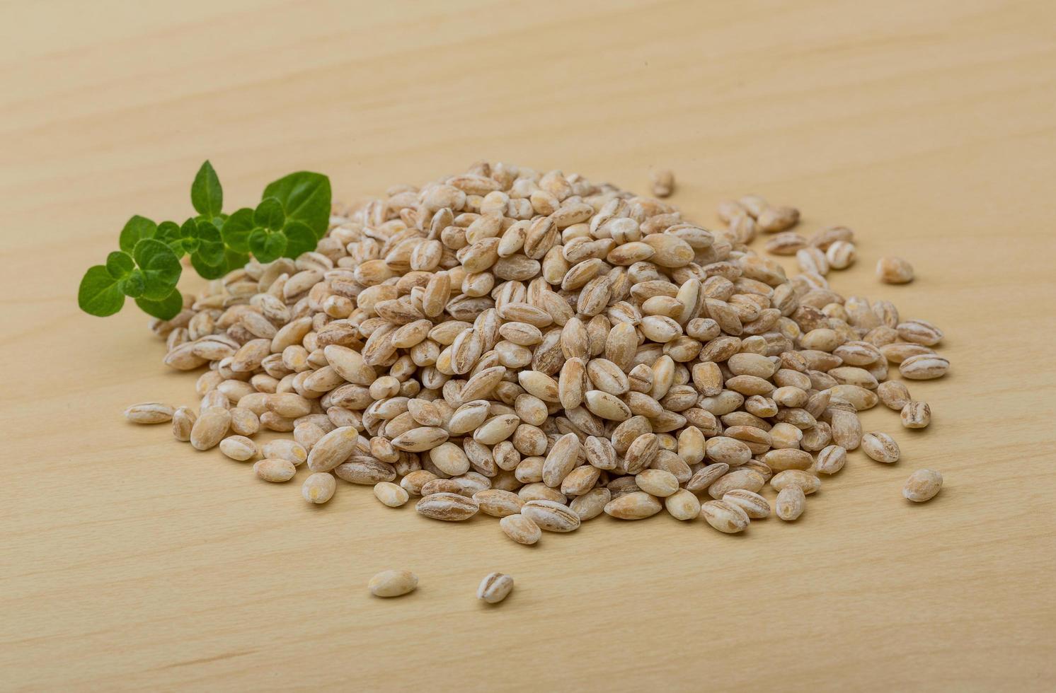 Pearl barley on wood photo