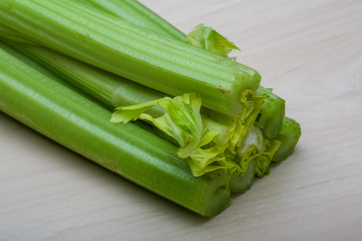 Celery on wooden background photo