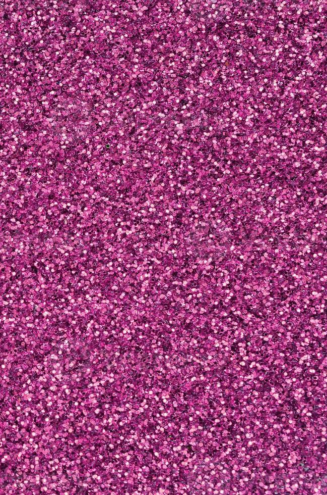 Pink decorative sequins. Background image with shiny bokeh lights from small elements photo