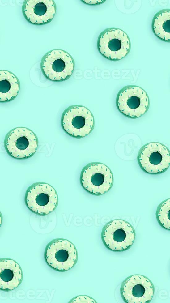 Many small plastic donuts lies on a pastel colorful background. Flat lay minimal pattern. Top view photo