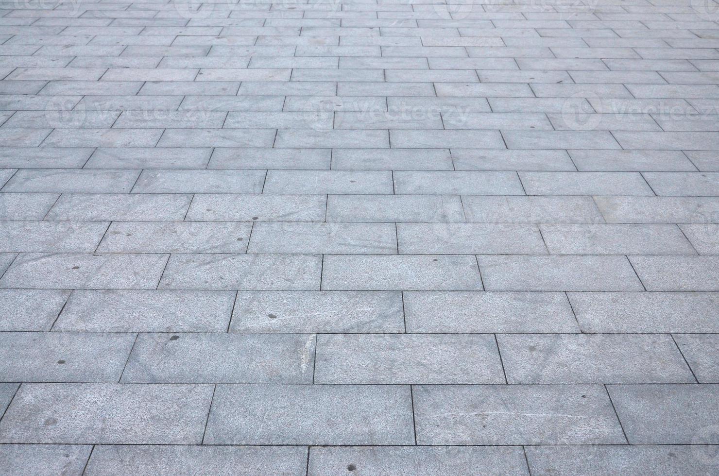 Fragment of the square paved of a large granite tiles photo