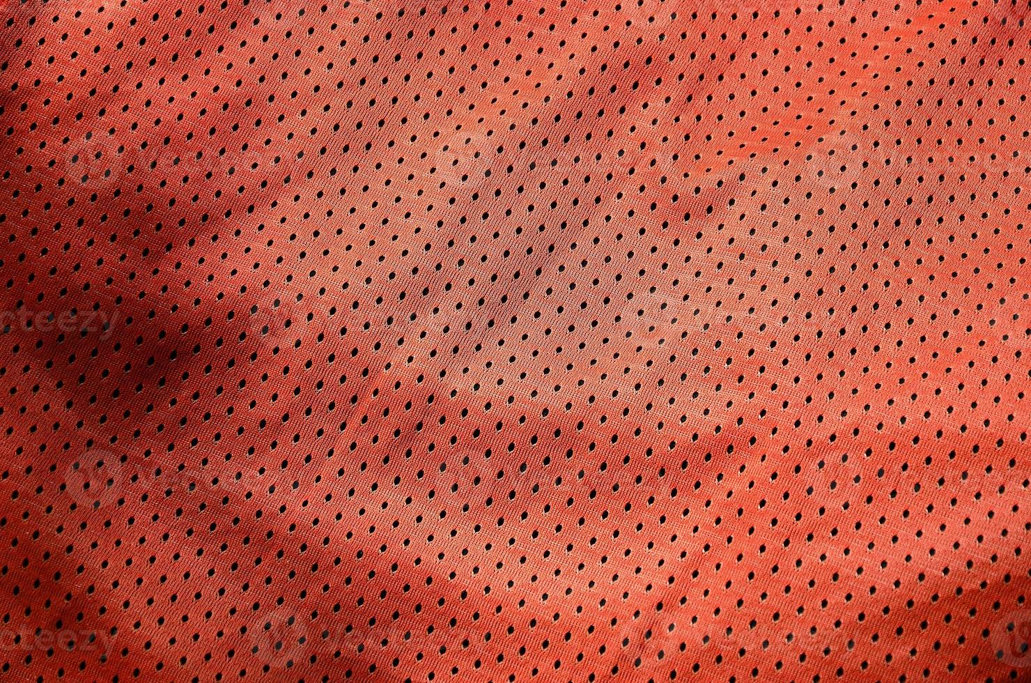 Sport clothing fabric texture background, top view of red cloth textile surface photo
