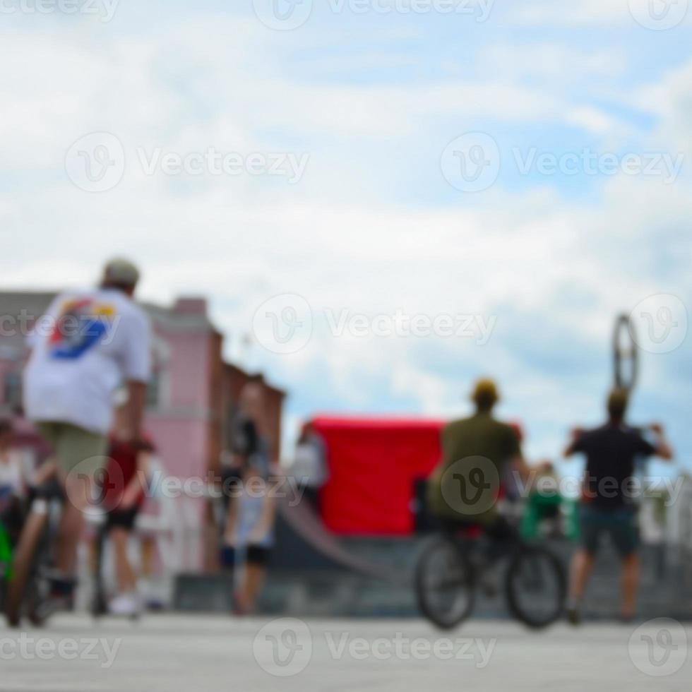 Defocused image of a lot of people with bmx bikes. Meeting of fans of extreme sports photo