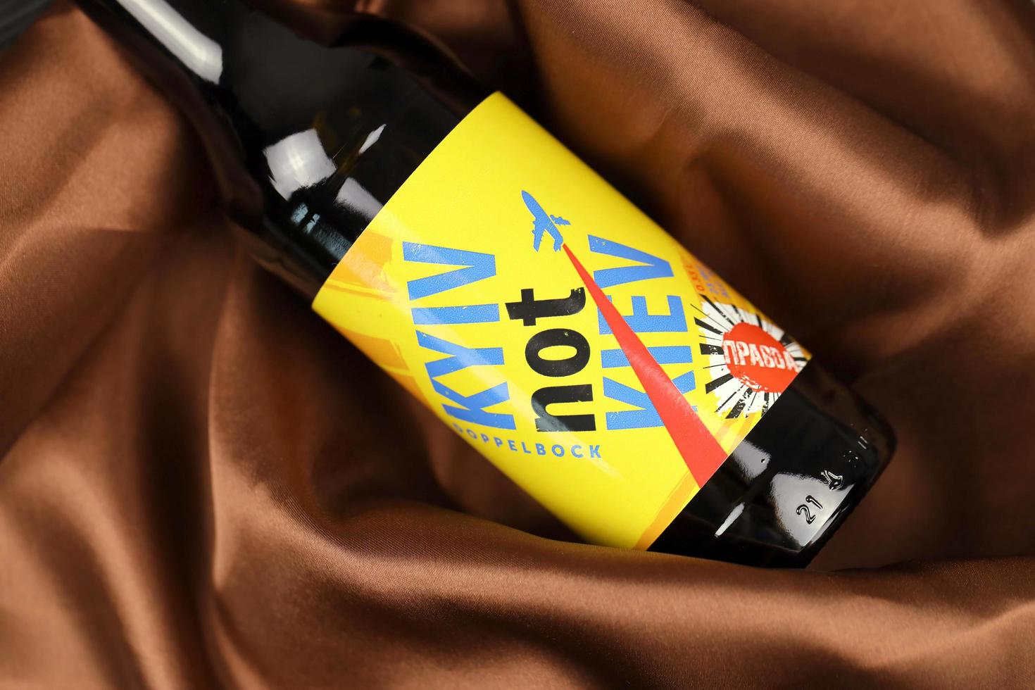 KHARKIV, UKRAINE - NOVEMBER 3, 2021 A bottle of beer featuring Ukrainian capital name Kyiv against his russian spelling Kiev brewed in Pravda Beer Theater in Lviv photo