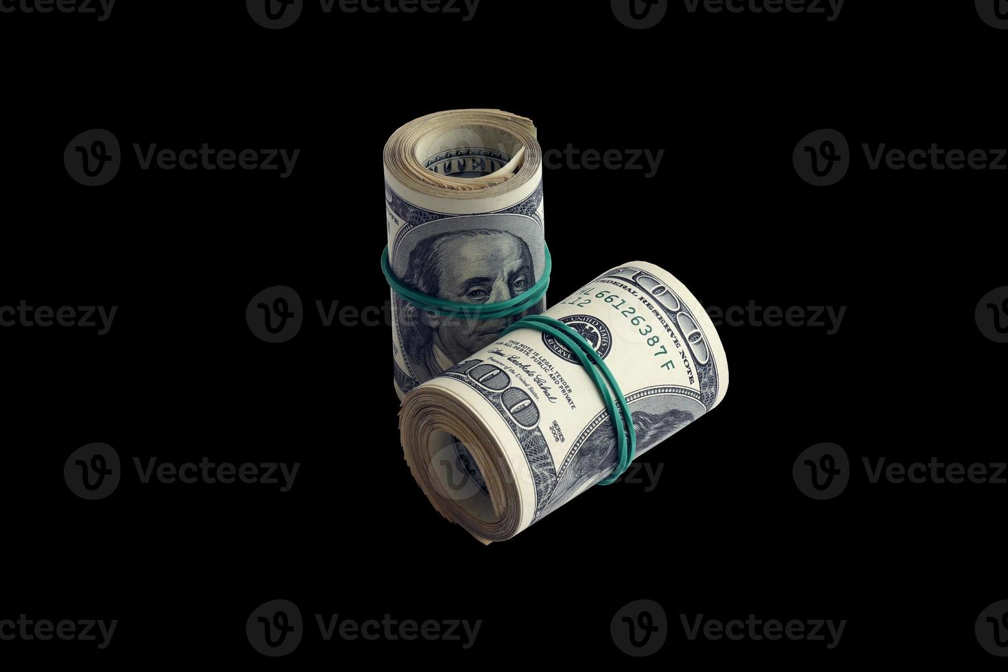 Bundle of US dollar bills isolated on black. Pack of american money with high resolution on perfect black background photo