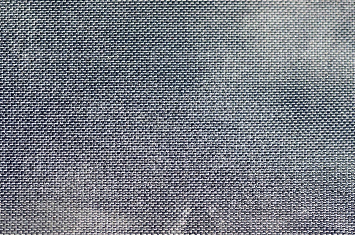 closeup of texture breathable mesh fabric in the black photo backpack. Texture of Black Plastic Weave Bag. Background image