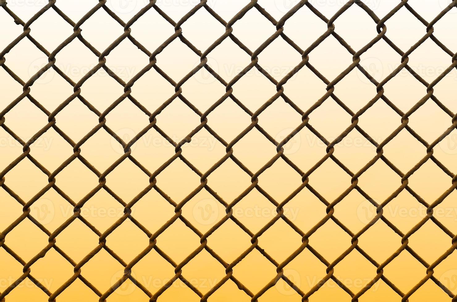 Texture of an old and rusty metal mesh on a neutral colored background photo