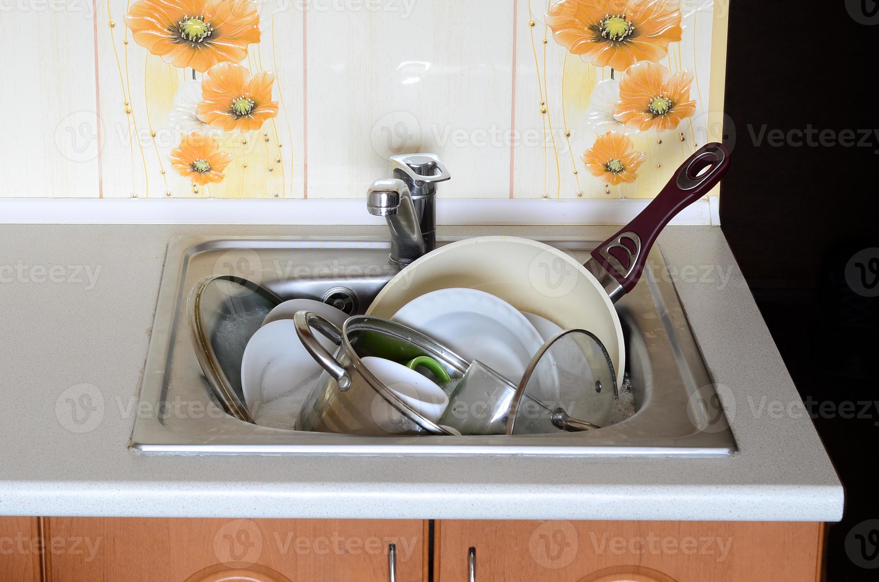 Dirty dishes and unwashed kitchen appliances filled the kitchen sink