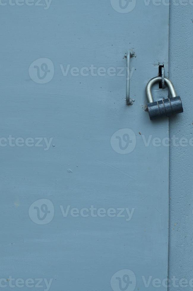 Metal surface from the outer old door with a lock photo