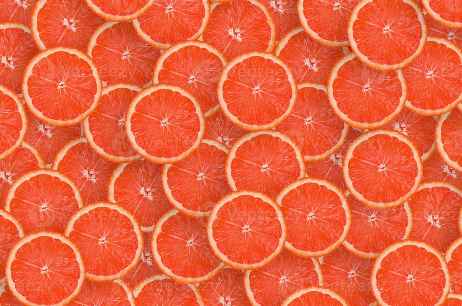 Pattern of red grapefruit citrus slices. Citrus flat lay photo