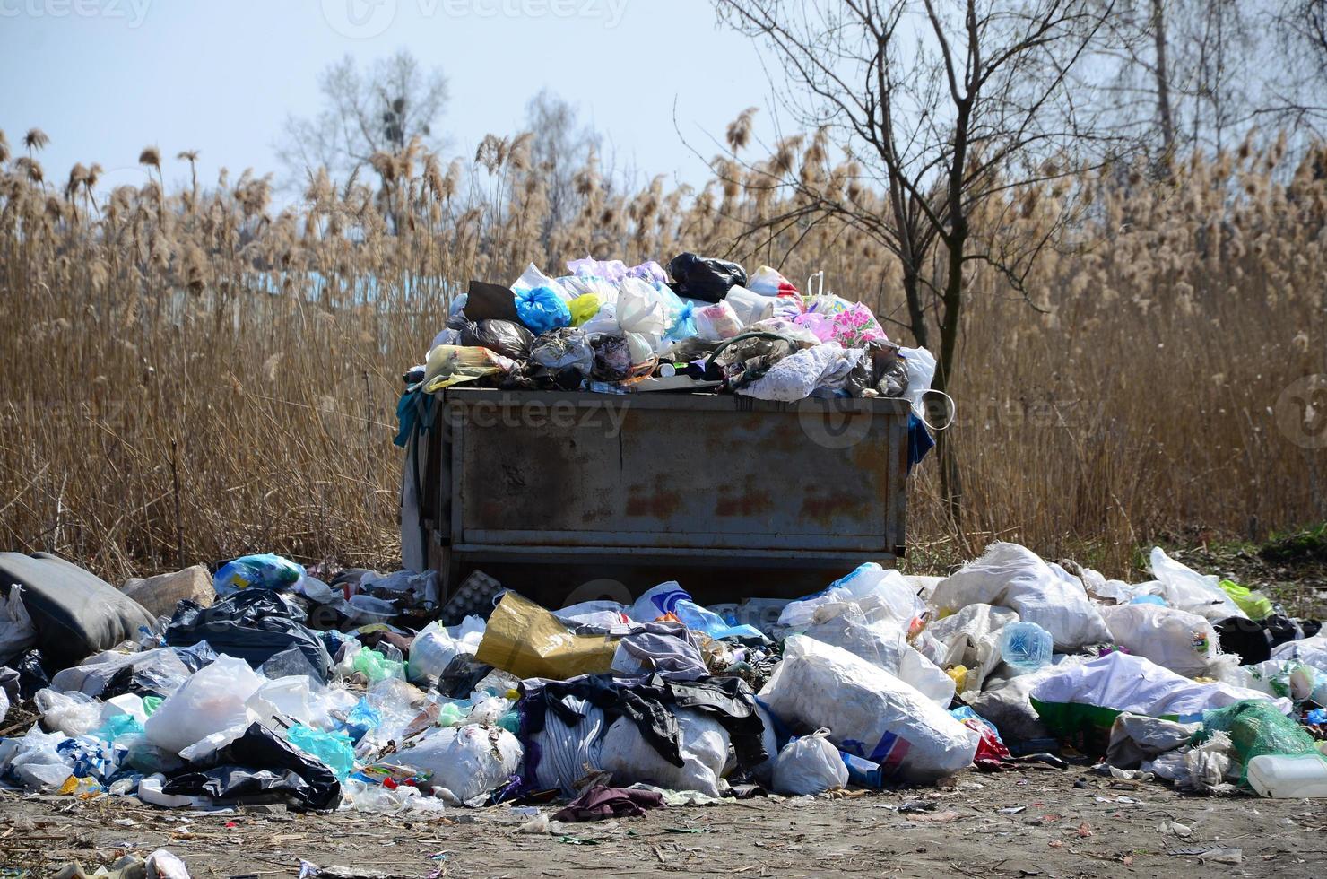 The garbage can is packed with garbage and waste. Untimely removal of garbage in populated areas photo
