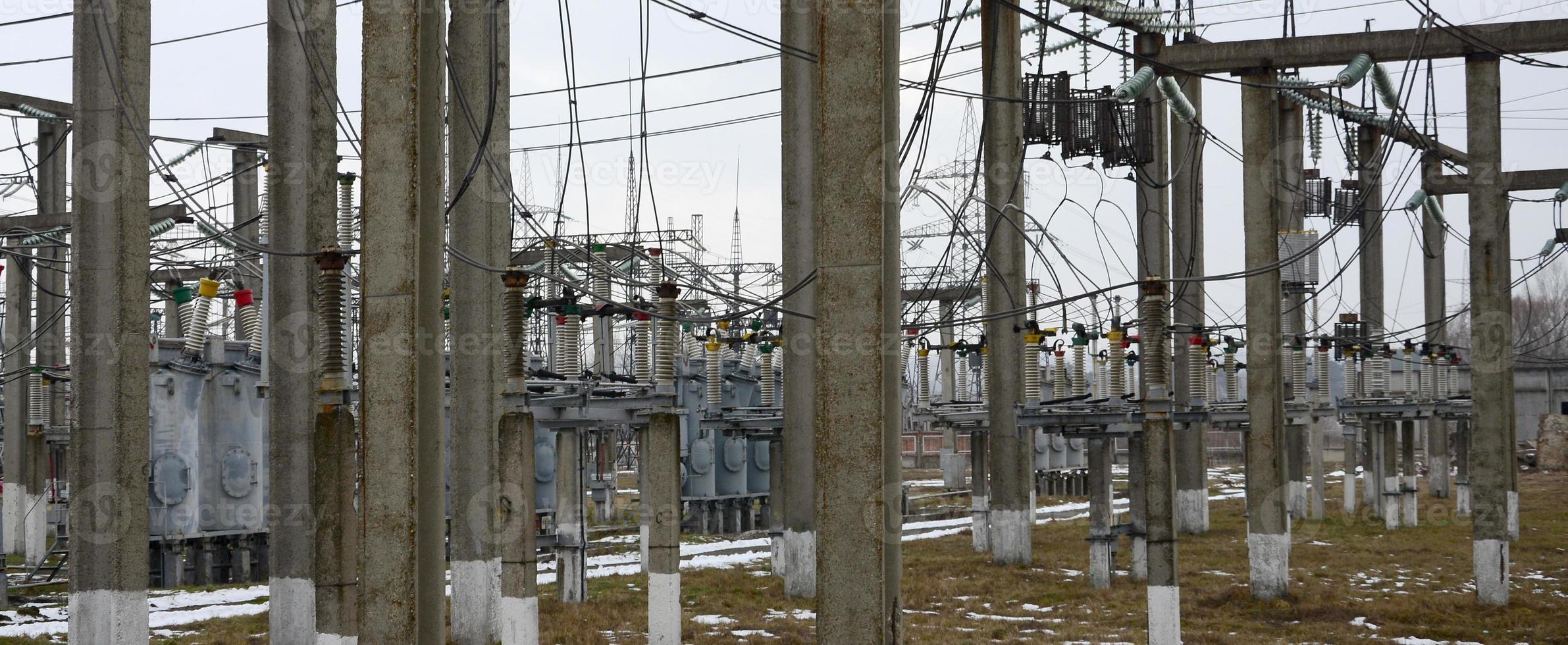 Power plant is a station of transformation. A lot of cables, poles and wires, transformers. Electro-energy. photo