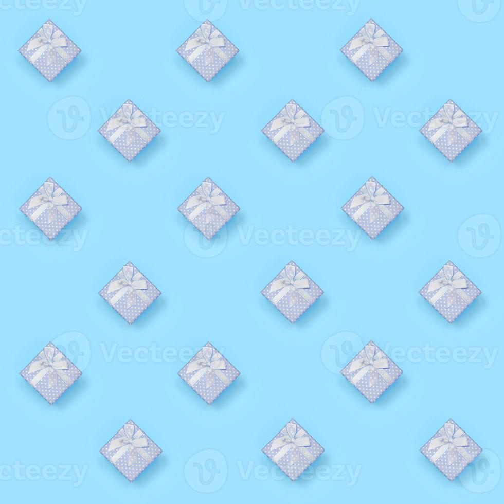 A lot of blue gift boxes lies on texture background of fashion pastel blue color paper in minimal concept photo