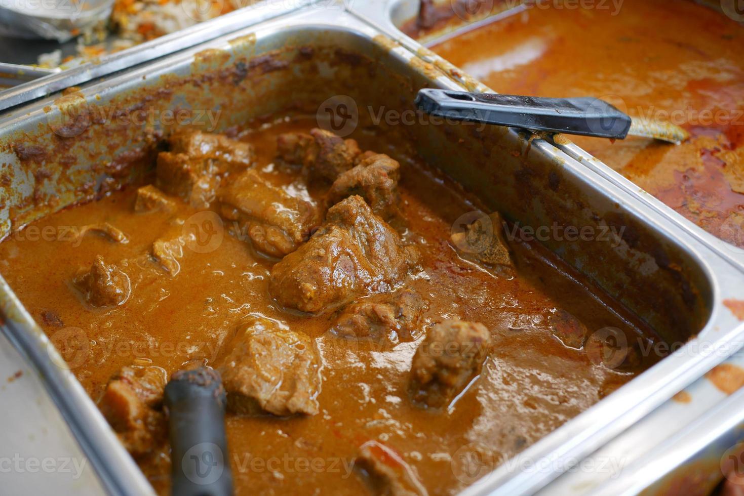 traditional Indian curry lamb masala in a bowl on table photo