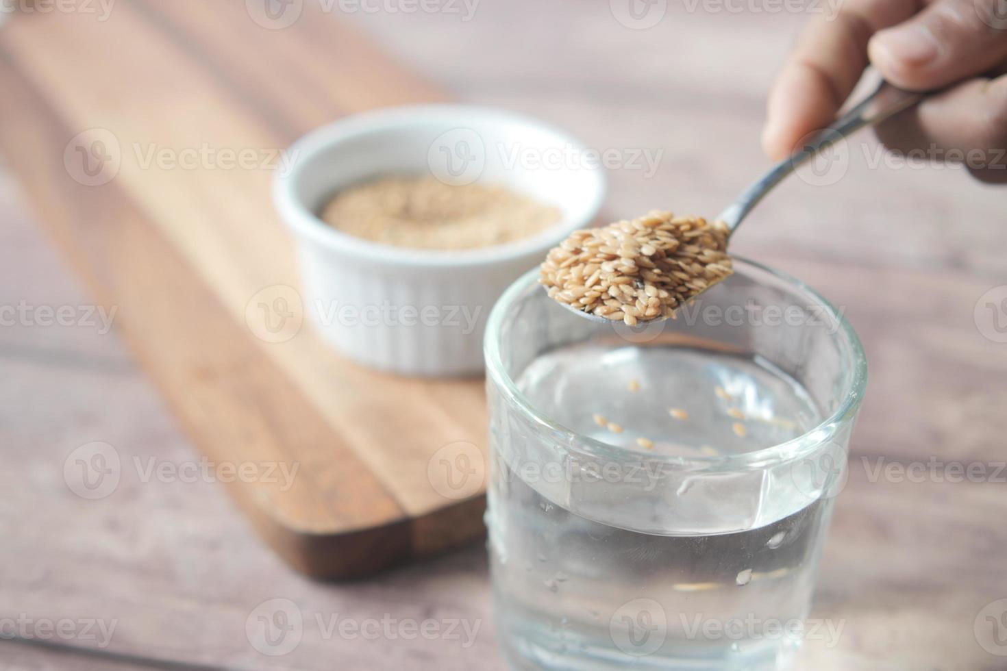 mixing flax seeds in glass of water 12774747 Stock Photo at Vecteezy