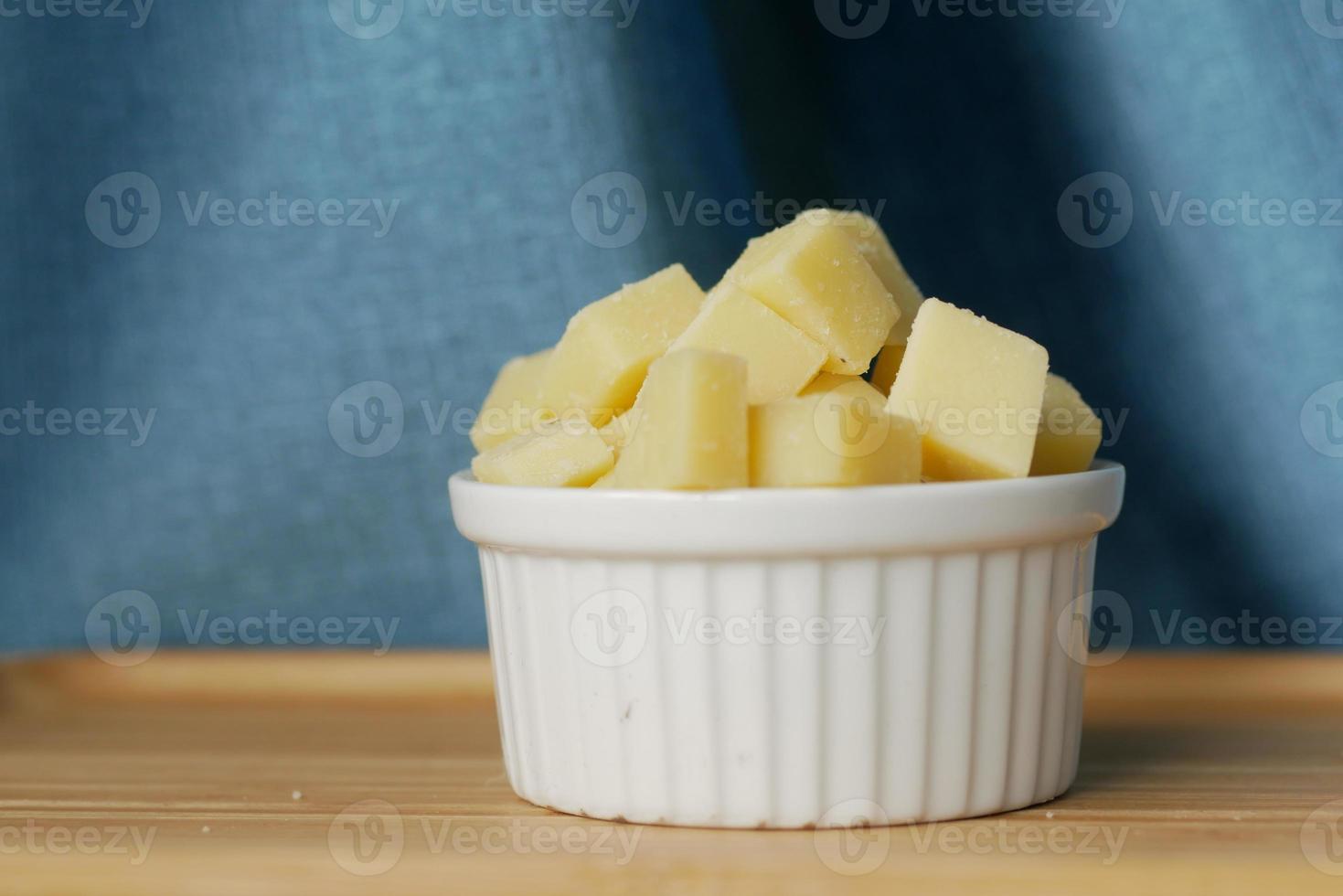 close up of cube shape fresh cheese on in a bowl photo