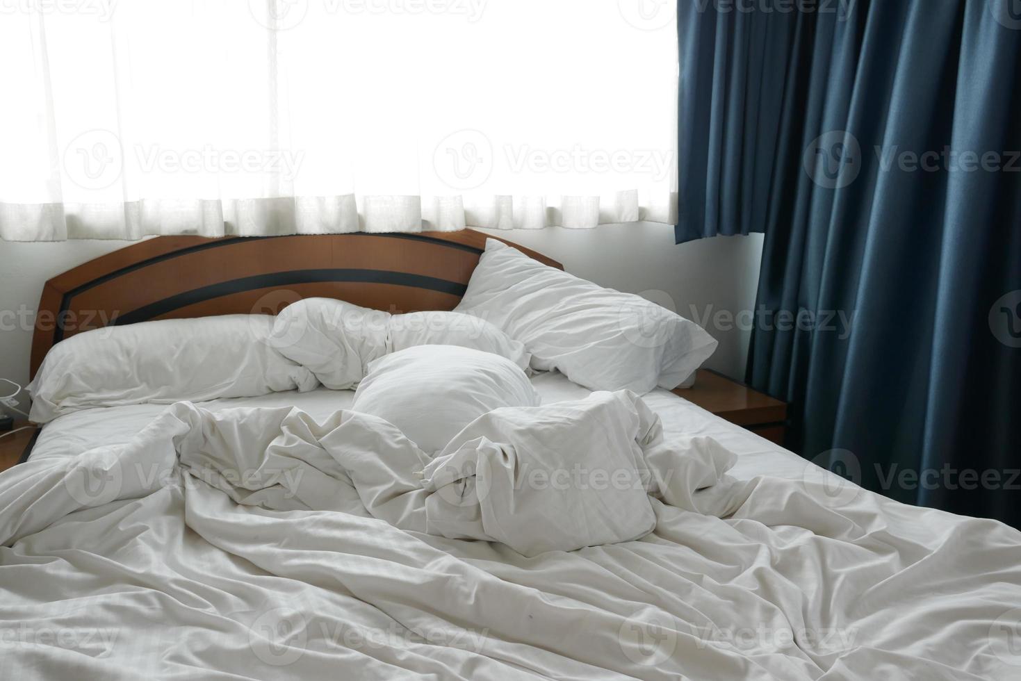 white color messy bed in early morning , messy bed after waking up photo