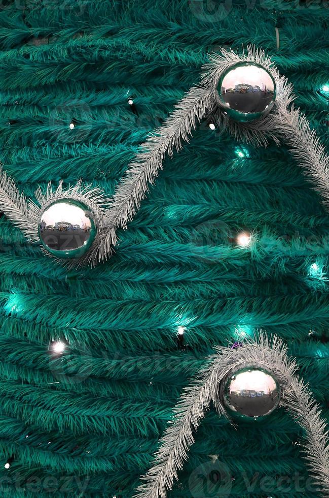 Texture of the wall decorated with New Year's fluffy ribbons and decorations in the form of glossy balls photo