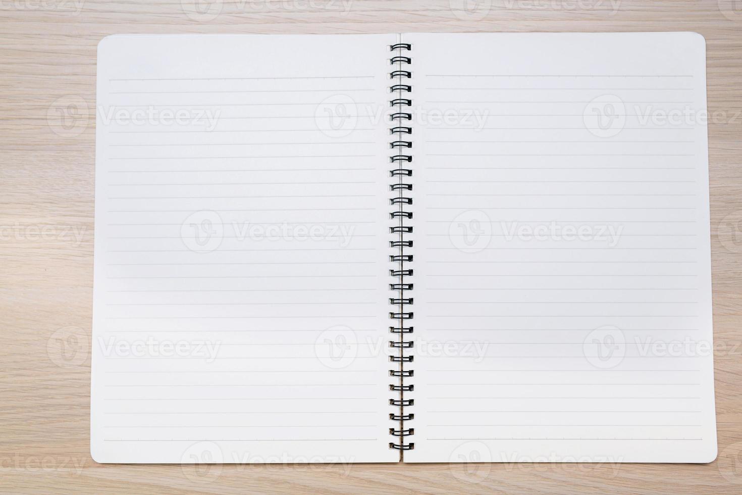 Notepad on the wooden desk, View from above with copy space photo