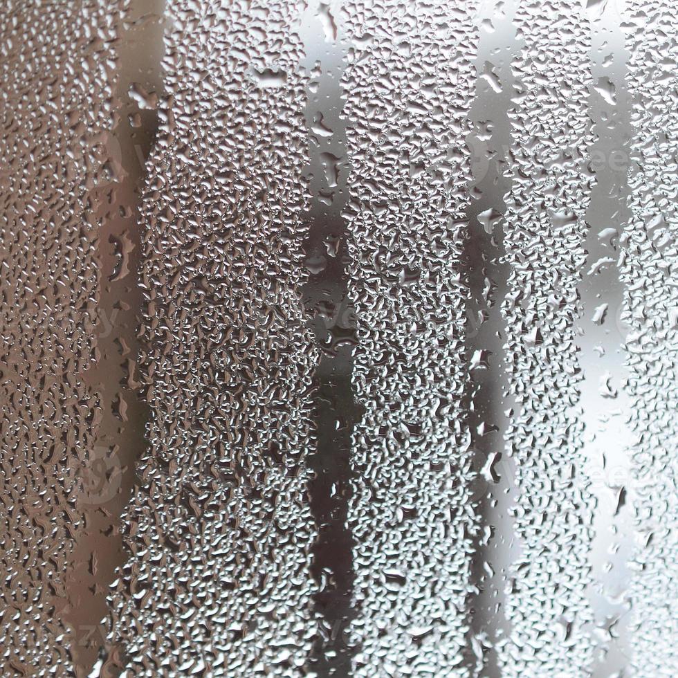 The texture of a misted glass with a lot of drops and condensation flows. Background image photo