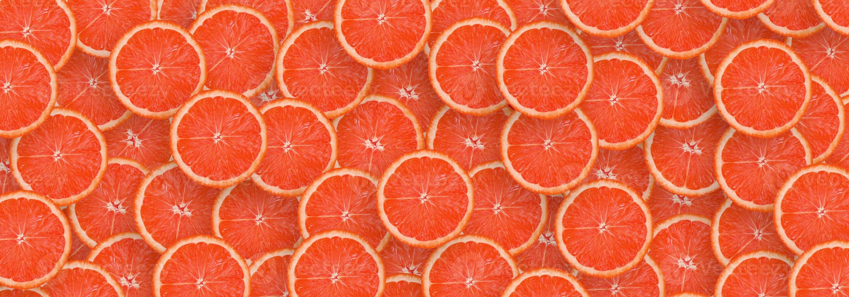 Pattern of red grapefruit citrus slices. Citrus flat lay photo