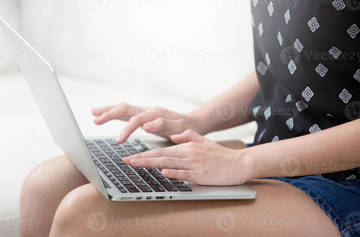 woman freelance is working business on a new project on laptop computer typing keyboarding on social network while relaxing at home. photo