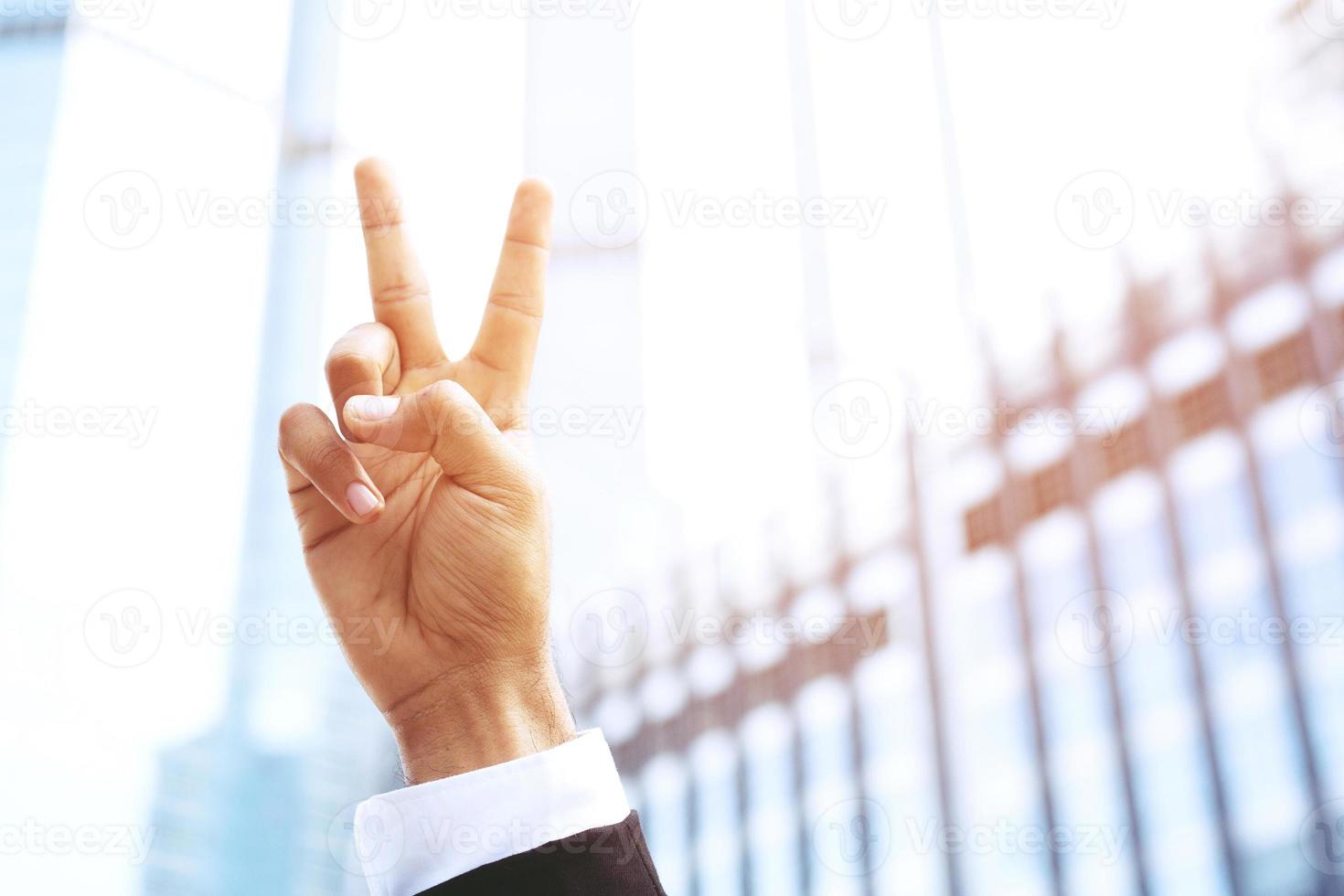 people businessman suit raising hand with two fingers and three fingers up in the peace or victory symbol symbol sign language The success of the organization. photo