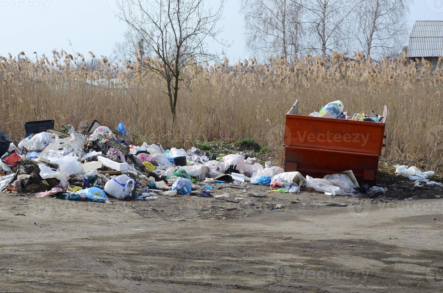 The garbage can is packed with garbage and waste. Untimely removal of garbage in populated areas photo