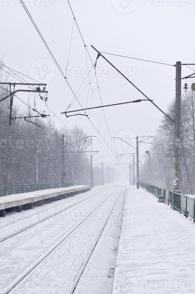 Railway station in the winter snowstorm photo