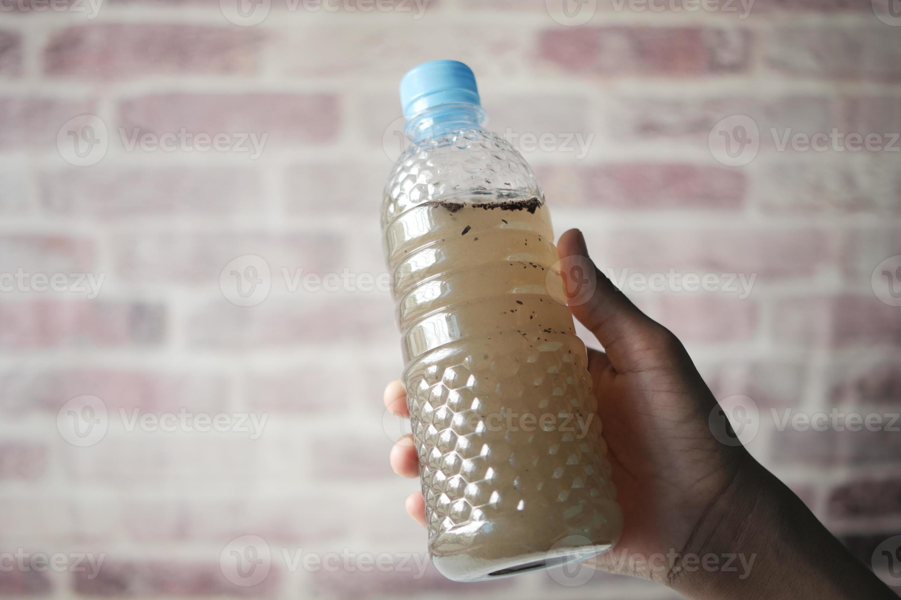 holding dirty bottle of water 12775265 Stock Photo at Vecteezy