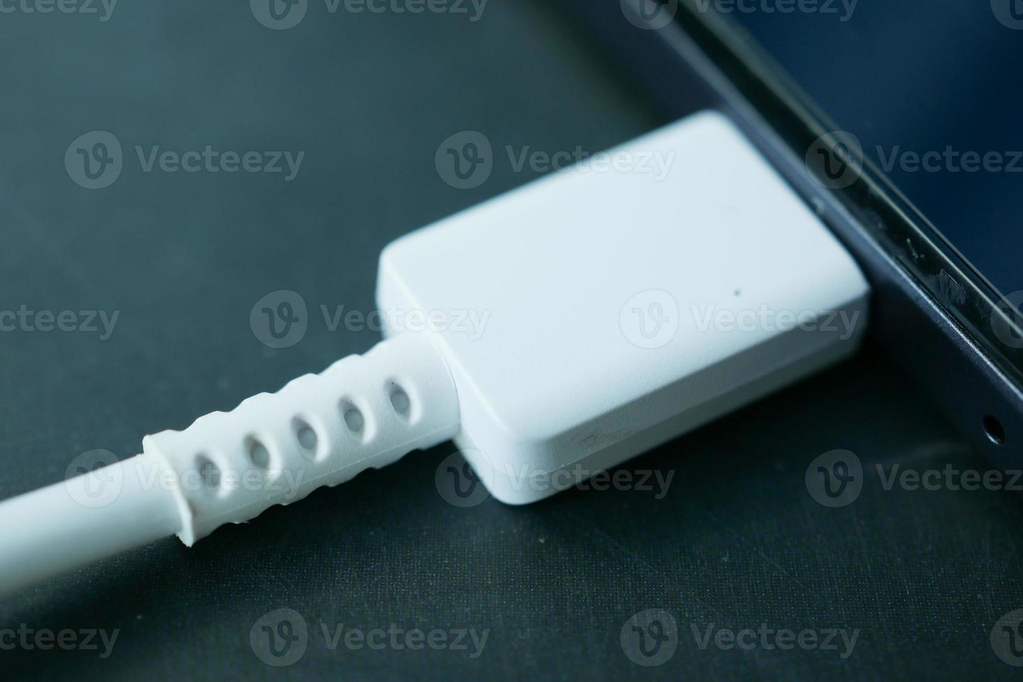 charging s digital tablet with a cable on white background photo