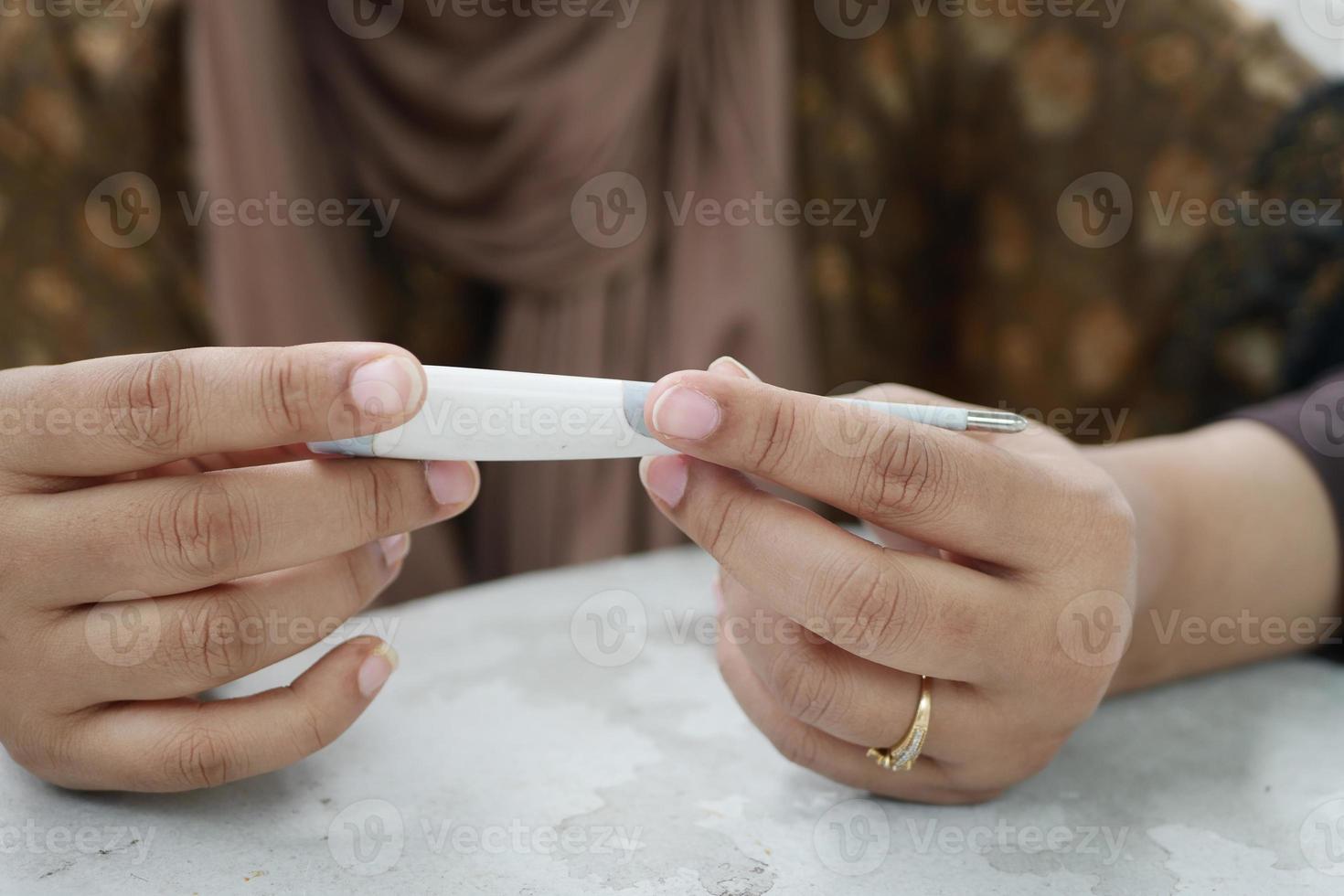 women hand measuring blood sugar level photo