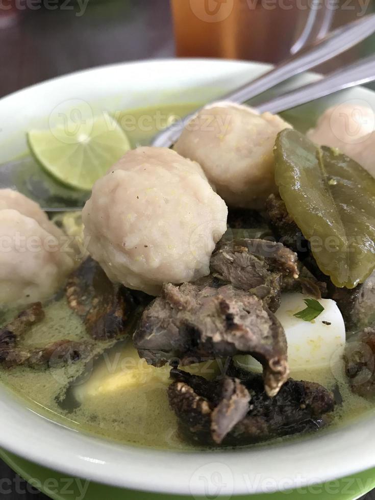 Soto is a typical Indonesian food with liver and meatball toppings plus lime as an additional flavoring. Inside there is shredded chicken with delicious warm rice photo