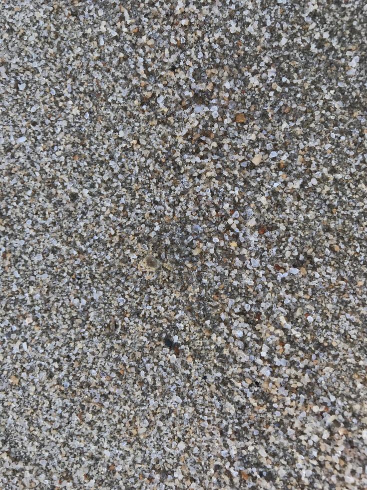This is a picture of a background of sand on the beach that has just been washed away by the waves photo