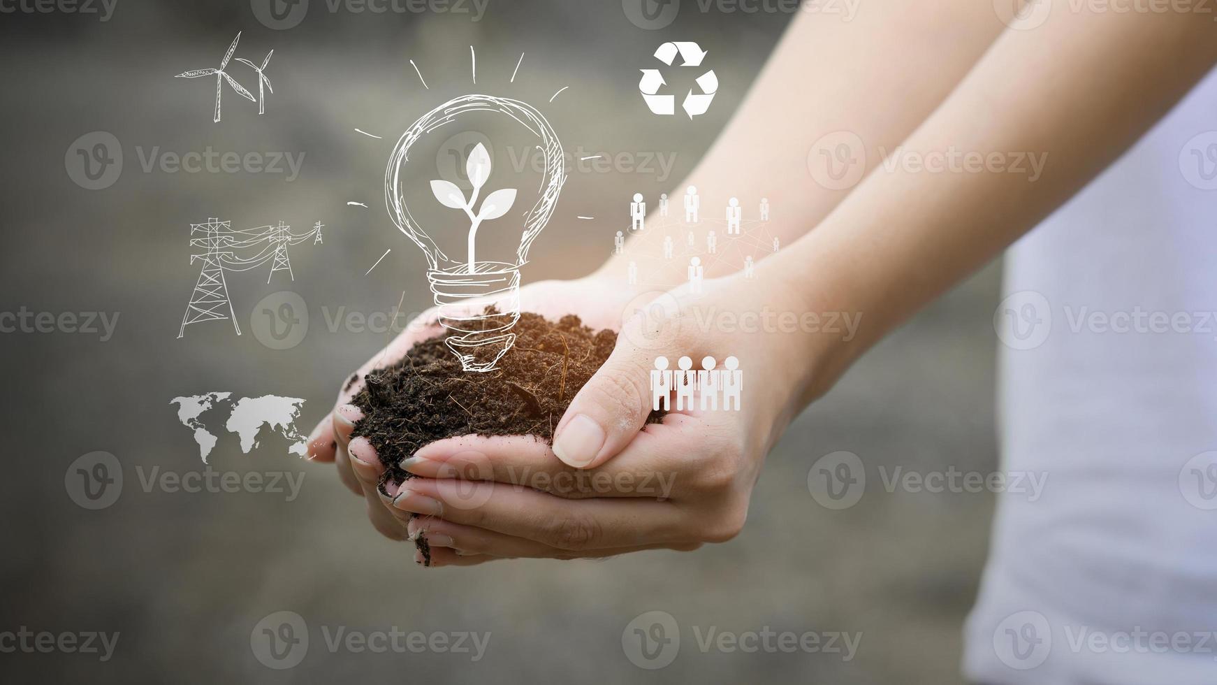 Human hand is holding fertile soil , concept of ecological sustainability . photo