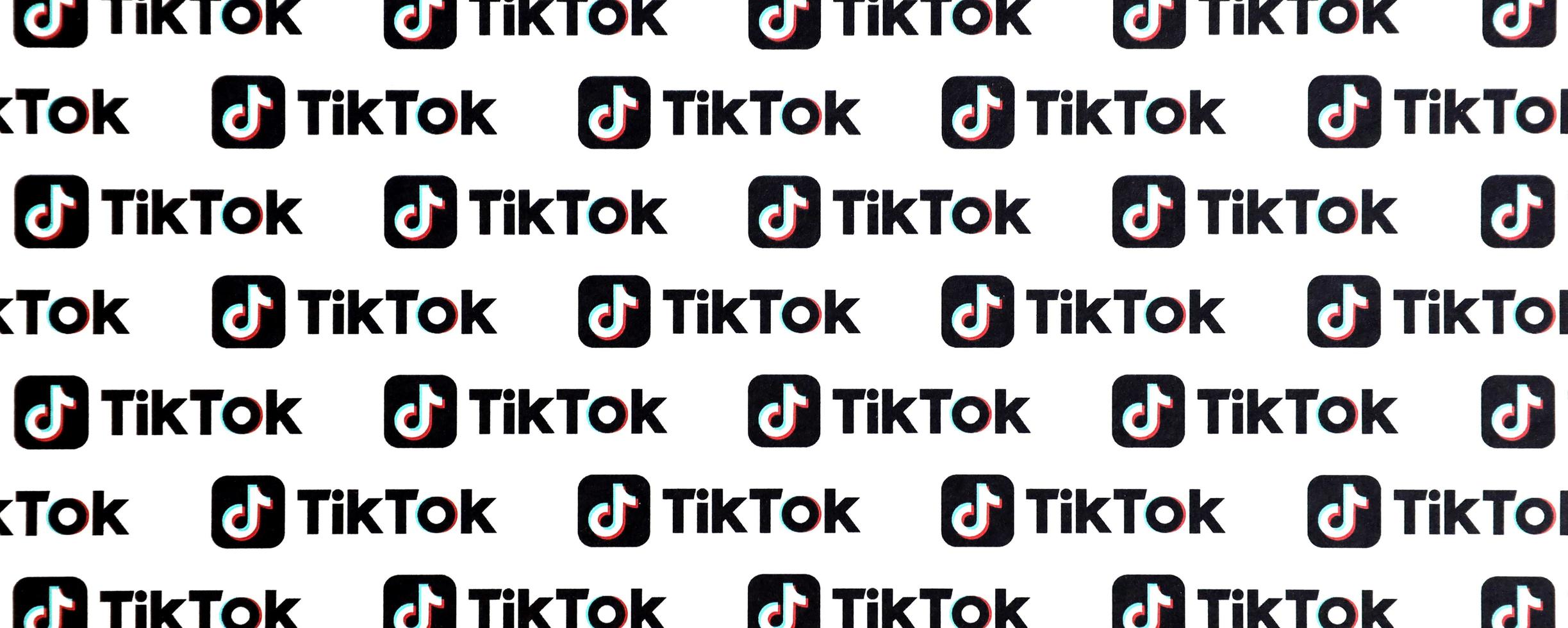 TERNOPIL, UKRAINE - MAY 2, 2022 Many TikTok logo printed on paper. Tiktok or Douyin is a famous Chinese short-form video hosting service owned by ByteDance photo