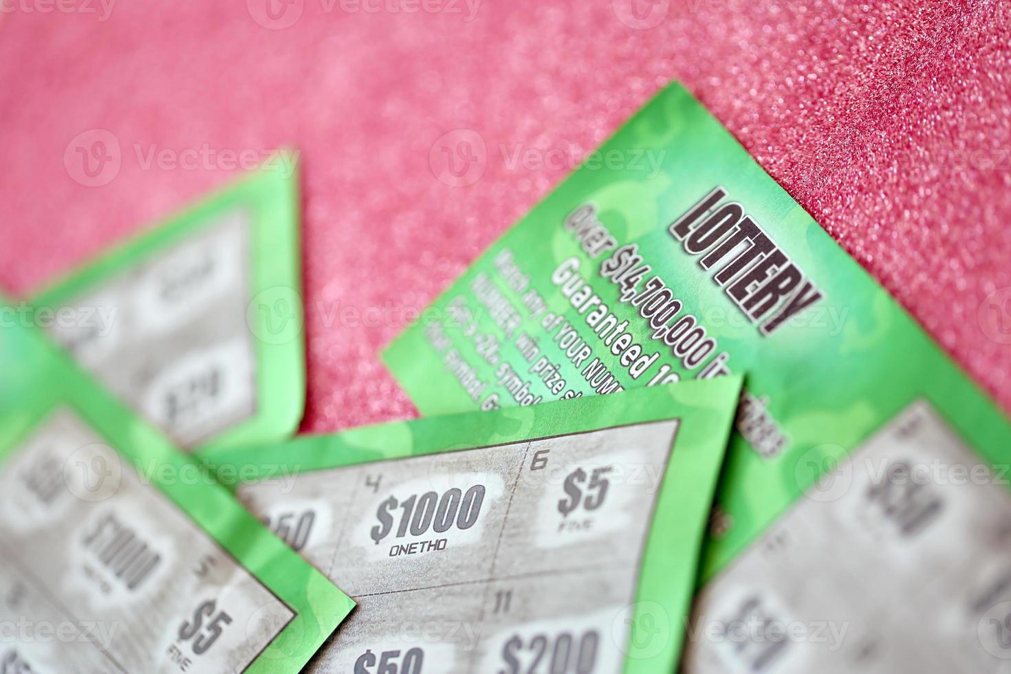 Close up view of green lottery scratch cards. Many used fake instant lottery tickets with gambling results. Gambling addiction photo