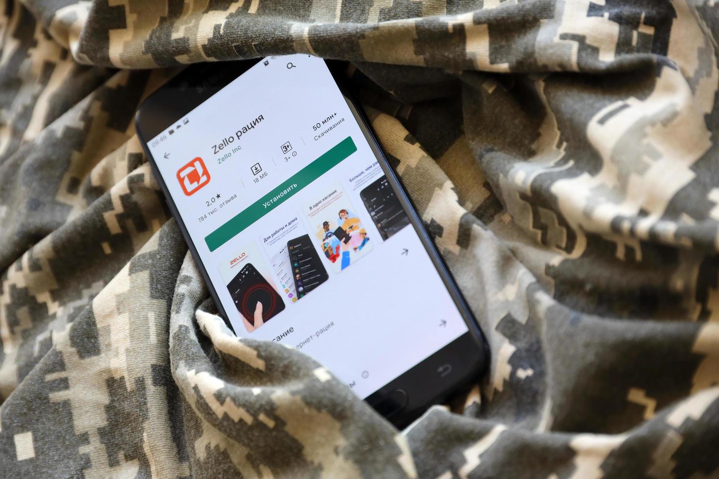 TERNOPIL, UKRAINE - APRIL 24, 2022 Zello Walkie Talkie mobile app logo from Play Market on phone screen close up on ukrainian military camouflage photo