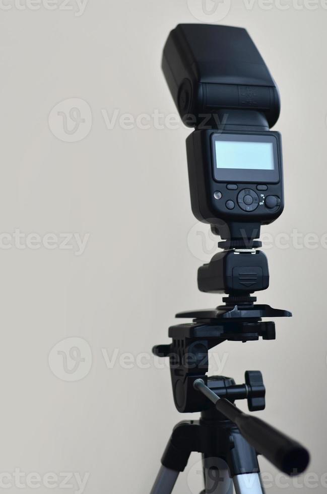 Speedlight gun with trigger set mounted on tripod photo