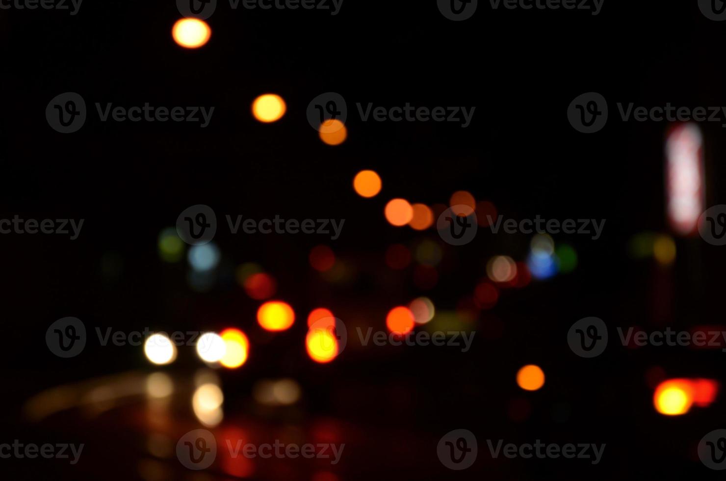 Blurred night scene of traffic on the roadway. Defocused image of cars traveling with luminous headlights. Bokeh Art photo