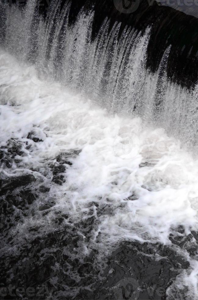 A picture of the flowing water. The dam is designed to regulate the water level in rivers within the city and to provide technical water to industrial objects photo