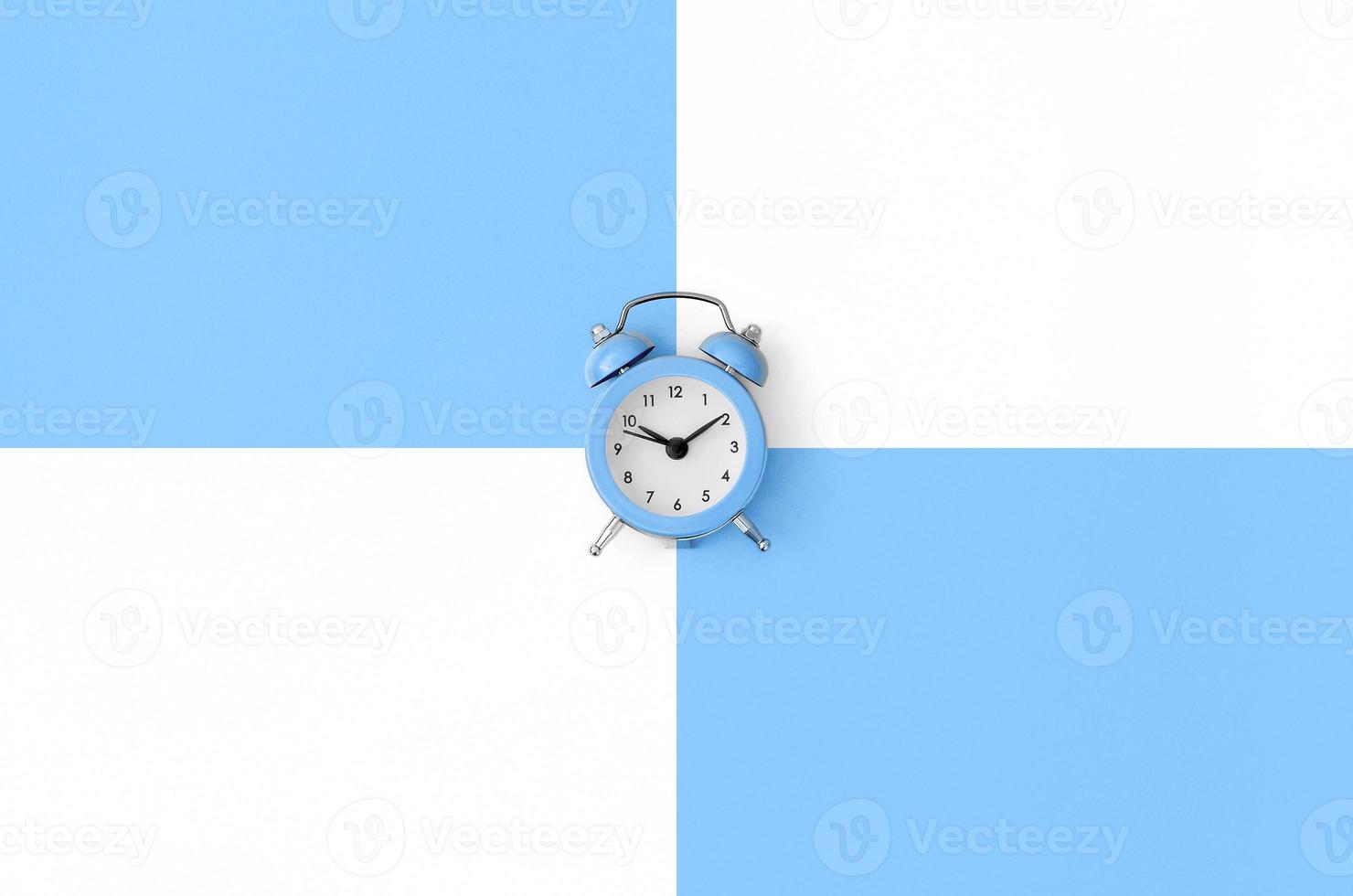 Minimalism flat lay top view. Alarm clock photo