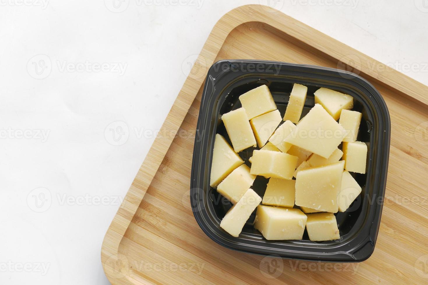 close up of cube shape fresh cheese on in a bowl photo
