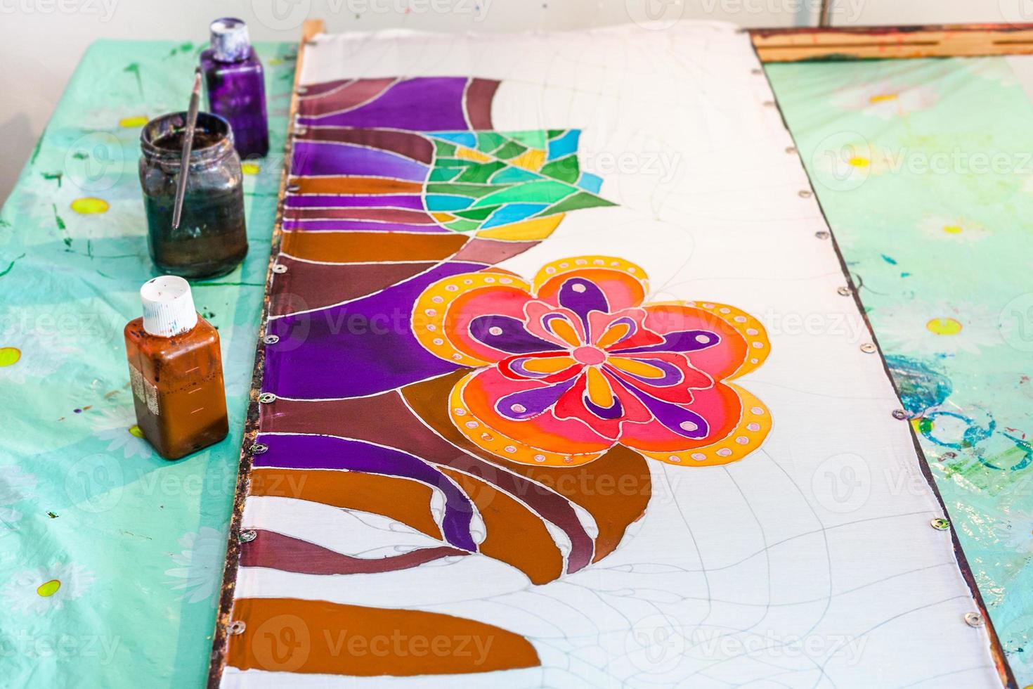 batik painting on silk fabric stretched on frame photo