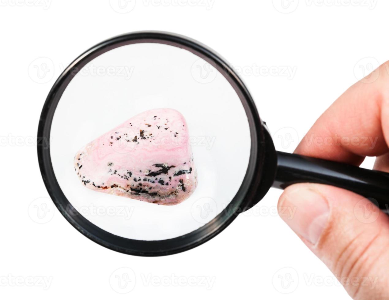 view of rhodochrosite gem stone through magnifier photo