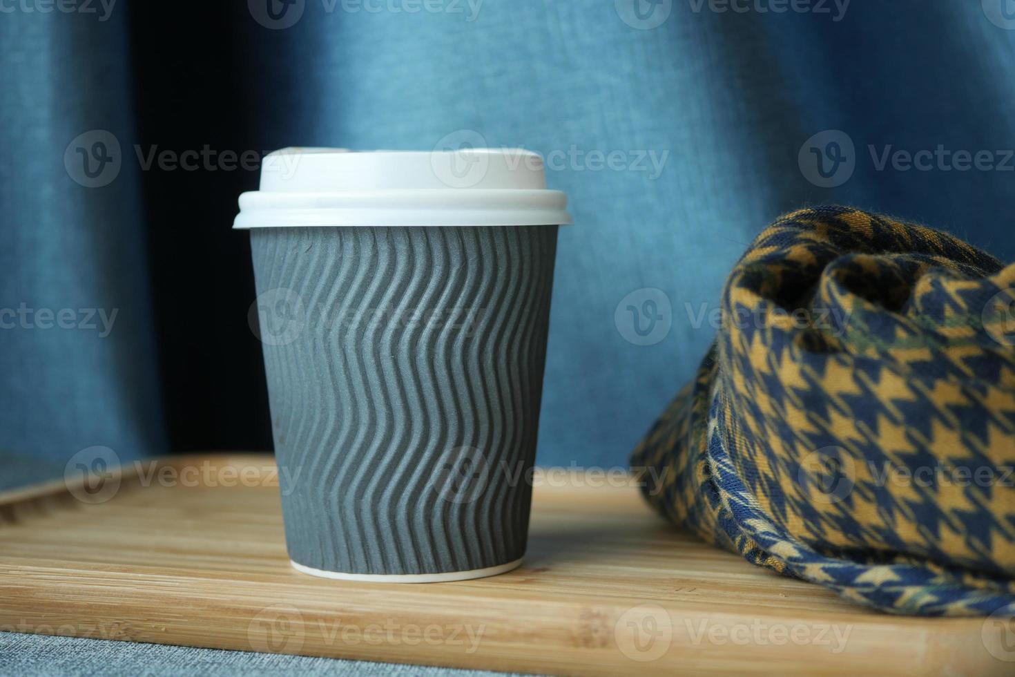 take away paper coffee cup o on cafe table photo