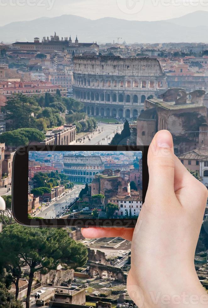 tourist taking photo of street to Coliseum, Rome