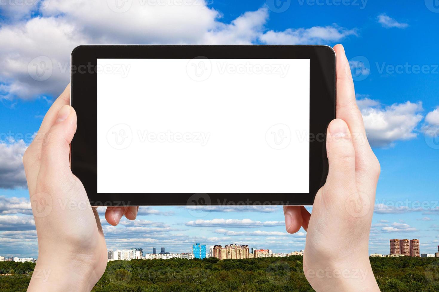 tourist photographs sky with clouds over town photo